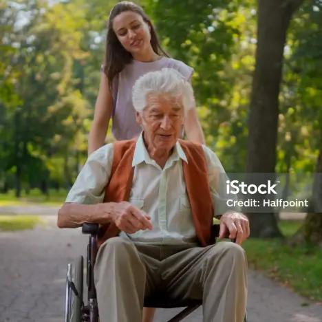 Elderly couple sitting on a bench outdoors